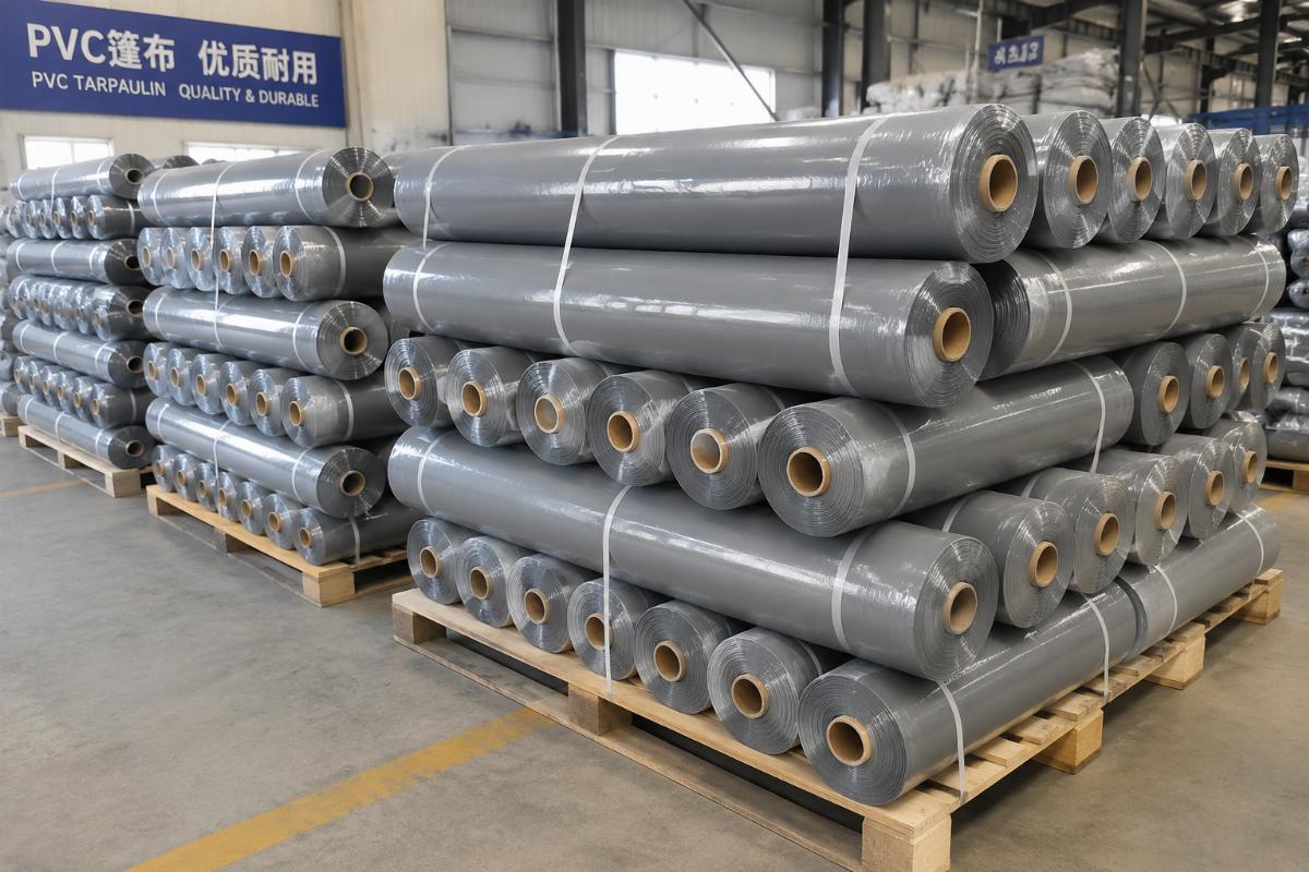 Grey custom color PVC tarpaulin roll stacked for bulk shipment