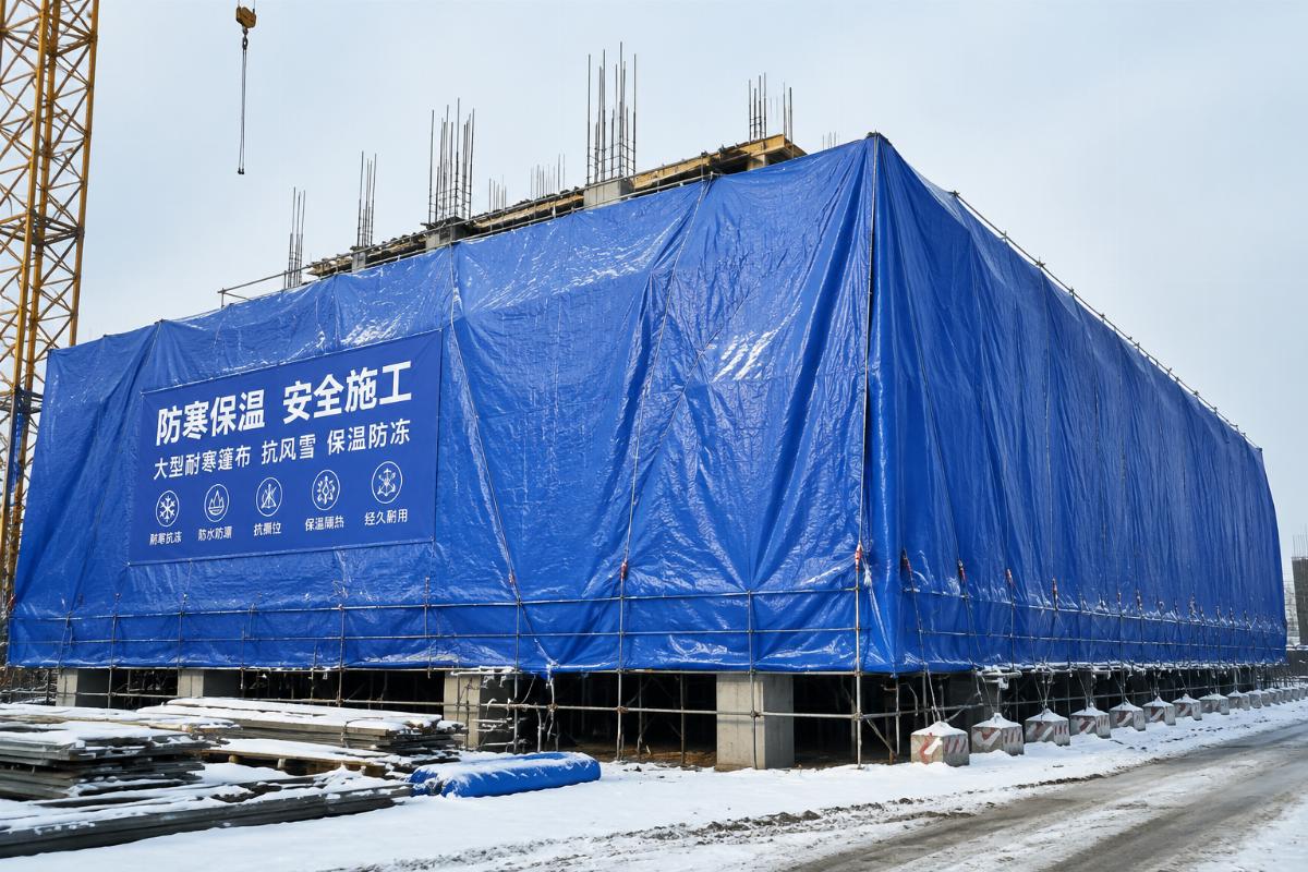 Large format cold resistant tarpaulin installed on winter construction site