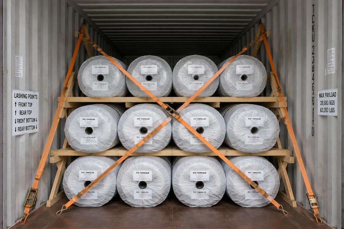Lashing and packaging setup for PVC tarpaulin rolls inside a shipping container
