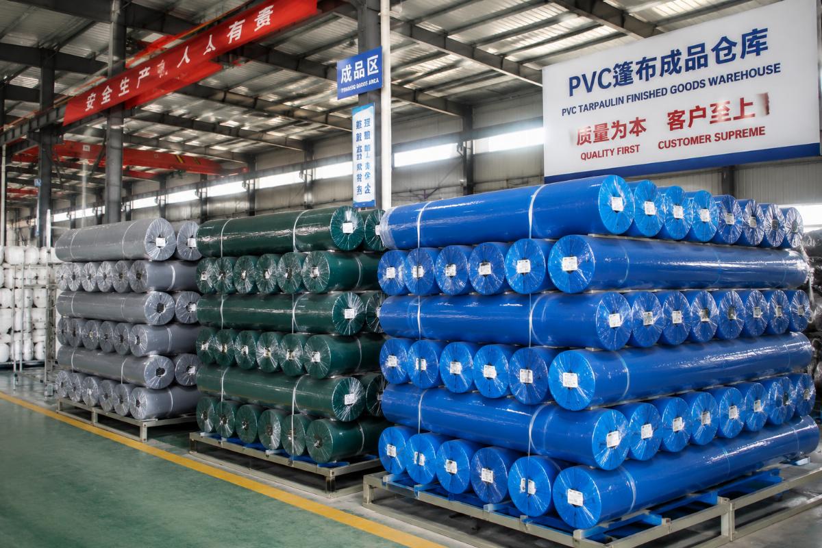 Ready-made PVC tarpaulin stock staged for bulk shipment at a Chinese factory